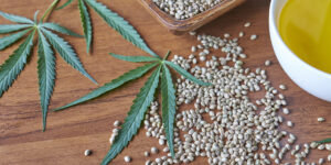 A table full of weed seeds and plants next to CBD oil